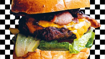 Close up burger beef lettuce bacon cheese gherkin