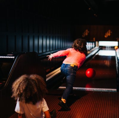 Man woman children bowling