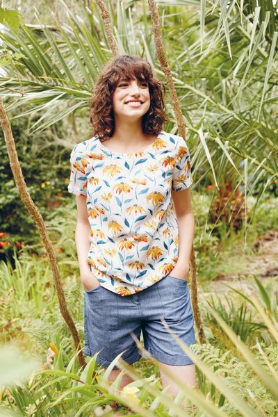 Woman floral t-shirt blue shorts foliage