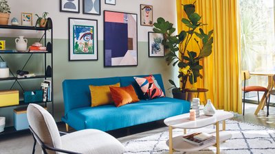 Blue sofa living room colourful artwork walls