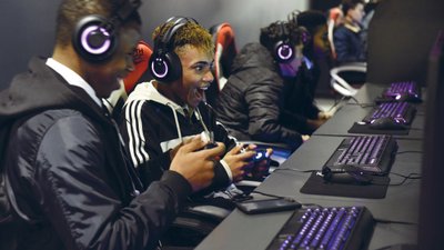 Boys laughing playing computer games