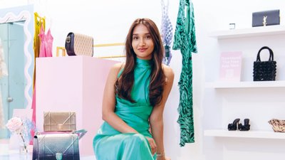 Woman in a green dress sitting in a shop