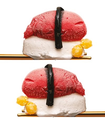 Ice cream sushi balanced on gold chopsticks