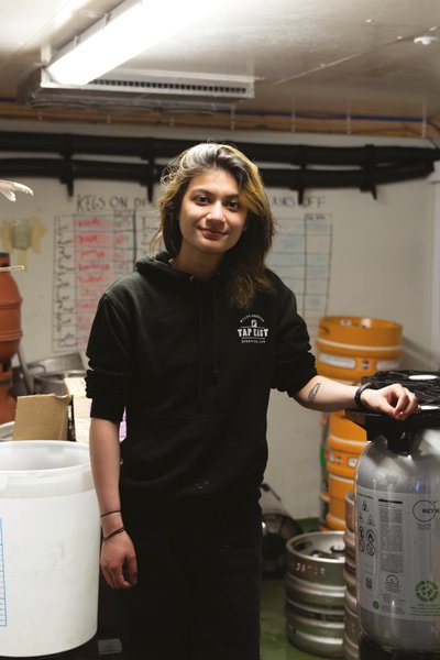 Woman standing brewing equipment