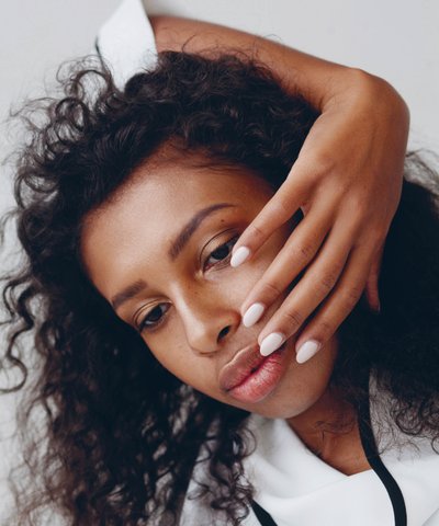 Woman with white painted nails