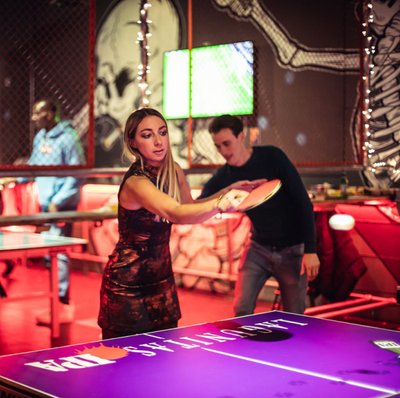 Man woman playing ping pong