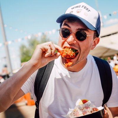 Person eating chicken wings